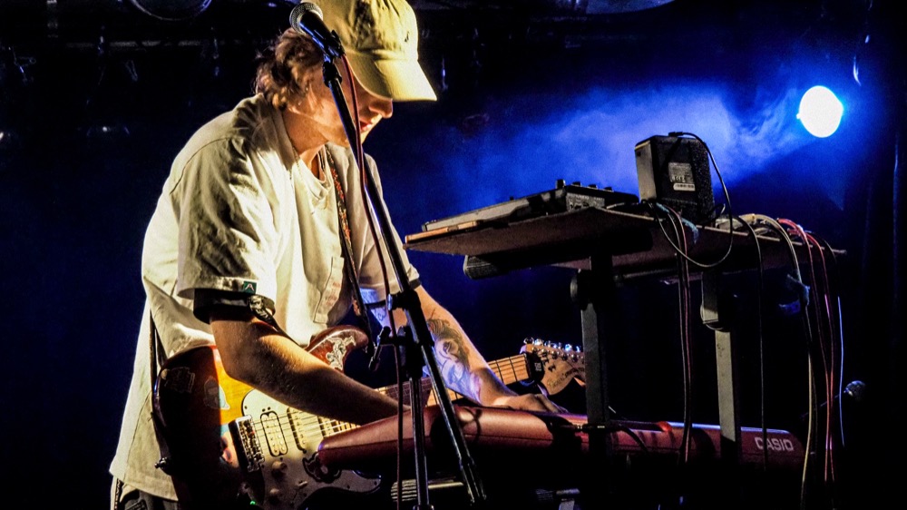 Moanzy playing guitar and keyboard live