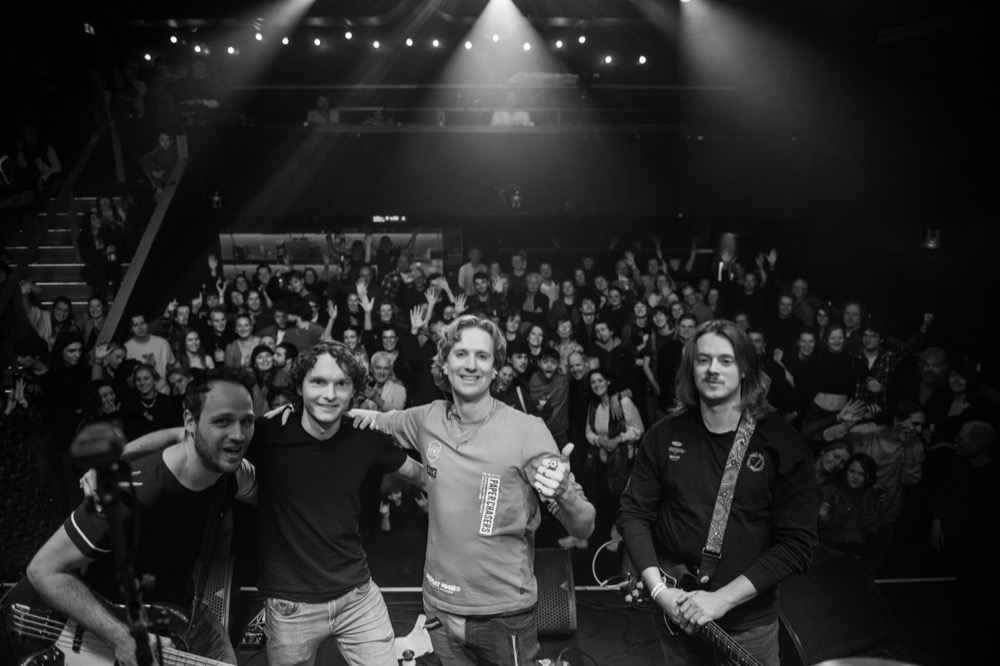 Band and crowd group photo after a show, black and white